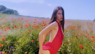 Thin girl fingering herself in the middle of some poppies